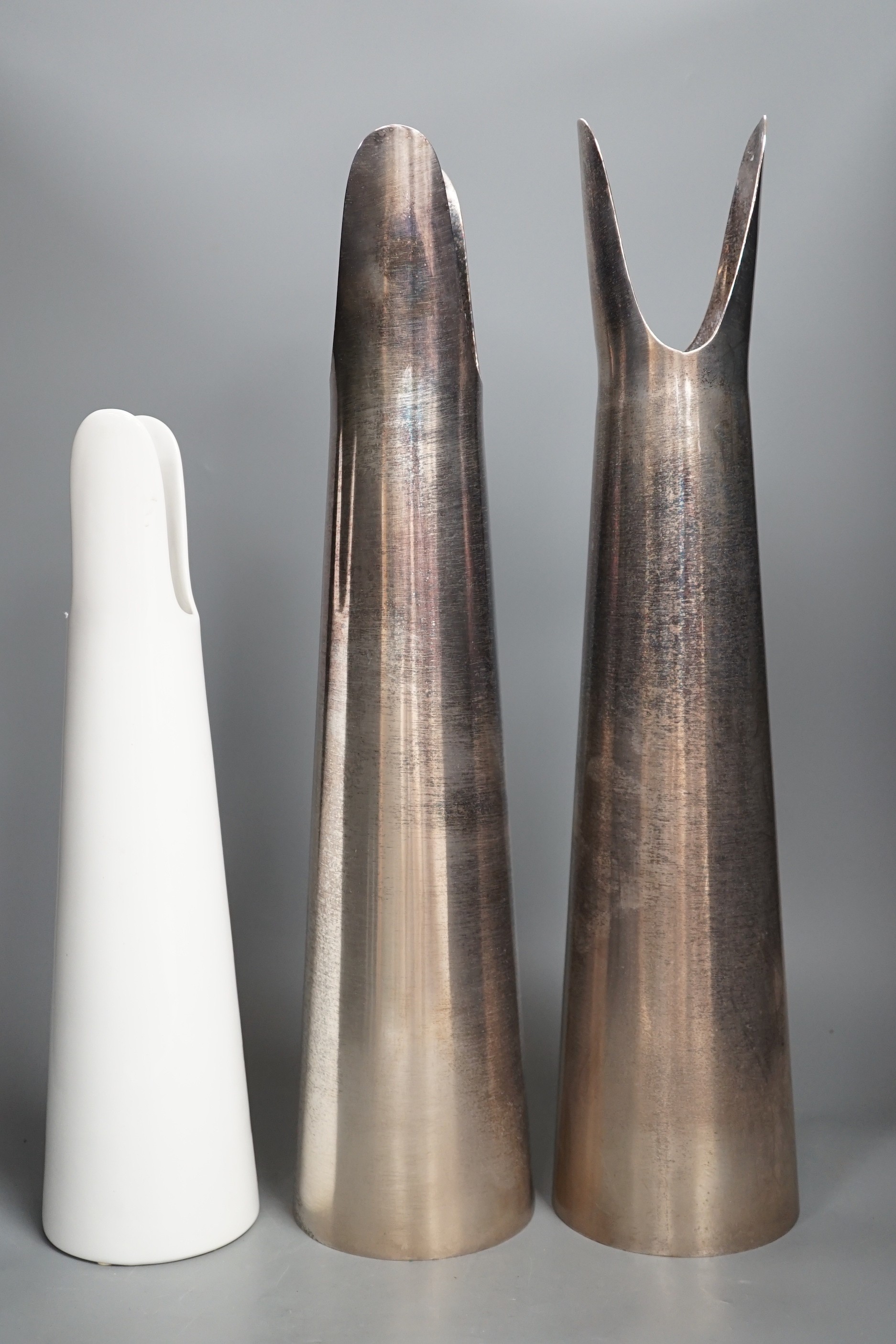 A Sophie Suchodolski ceramic vase and a pair of matching steel vases. Tallest 52cm